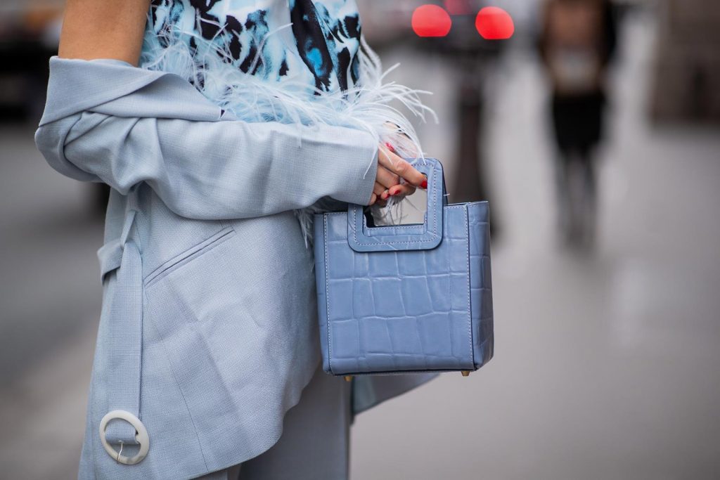 PARIS, FRANCE - FEBRUARY 25: Alexandra Lapp is seen wearing a suit style, light blue De La Vali suit, blue Shirley mini bag from Staud, 16Arlington satin top with feathers, Prada pumps in light blue, square-frame black Bottega Veneta sunglasses all from Net-A-Porter during Paris Fashion Week - Womenswear Fall/Winter 2020/2021 : Day Two on February 25, 2020 in Paris, France.