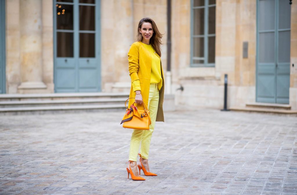 PARIS, FRANCE - FEBRUARY 26: Alexandra Lapp is seen wearing a yellow trend, leather coat in yellow from Milestone by Peter Hahn, yellow Looxent pullover from Peter Hahn, MYBC Jeans from Peter Hahn, slingback-pumps in orange from The Attico, 28 Hermes Kelly bag in orange, silk scarf from Hermes during Paris Fashion Week - Womenswear Fall/Winter 2020/2021 : Day Three on February 26, 2020 in Paris, France.