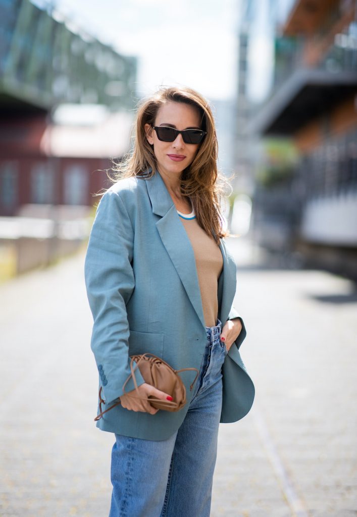 DUSSELDORF, GERMANY - JUNE 09: Alexandra Lapp is seen wearing a casual chic look, Victoria Beckham tanktop in beige, GRLFRND high waist Jeans Devon, double breasted blazer in blue from Low Classic, the Pouch mini clutch from Bottega Veneta and Dylan cat-eye sunglasses in black with silver all from NET-A-PORTER is seen on June 09, 2020 in Dusseldorf, Germany. 