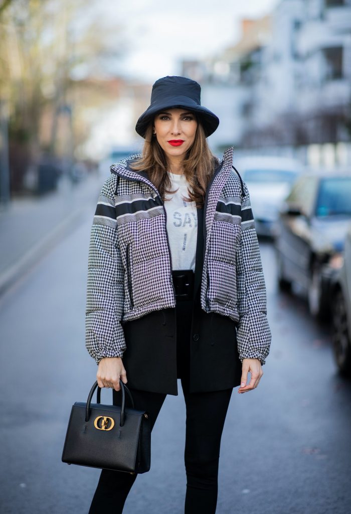 Alexandra Lapp is seen wearing one of her puffer jackets, CHRISTIAN DIOR puffer jacket in black and white, Zara puffer hat in Black, CHRISTIAN DIOR blazer in Black, CHRISTIAN DIOR t-shirt in white, CHRISTIAN DIOR St Honoré Tote bag in black,