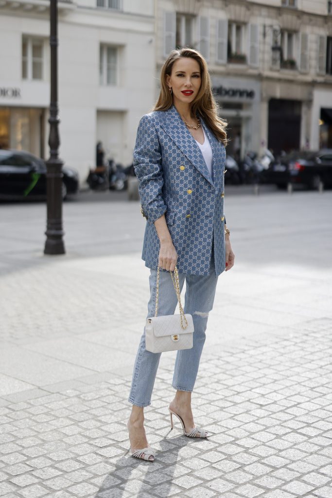 Alexandra Lapp is seen wearing GUCCI logo print blazer in the silver Gucci pattern, ZARA t-shirt in white, CITIZENS OF HUMANITY Premium Vintage denim trousers, AQUAZURA Gatsby sling pump, Chanel classic flap bag. Complete look by Breuninger