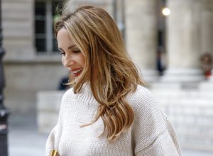 Alexandra Lapp is seen wearing her Winter highlights during Paris Fashion Week, such as coats, chunky knits, statement ear rings and accessories, as well as her signature make-up.