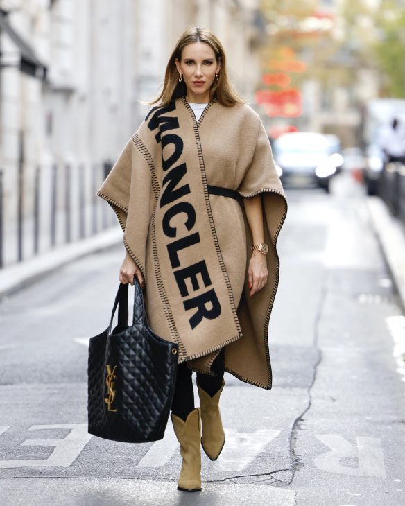 Alexandra Lapp is seen wearing her Winter highlights during Paris Fashion Week, such as coats, chunky knits, statement ear rings and accessories, as well as her signature make-up.