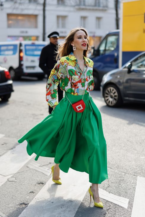 Alexandra Lapp is seen wearing colorful looks during Fashion Week in Paris. ODEEH blouse, C.WIRSCHKE green satin skirt, CHRISTIAN LOUBOUTIN Hot Chick pumps in yellow, FOR ART’S SAKE sunglasses, HERMES Kelly bag.